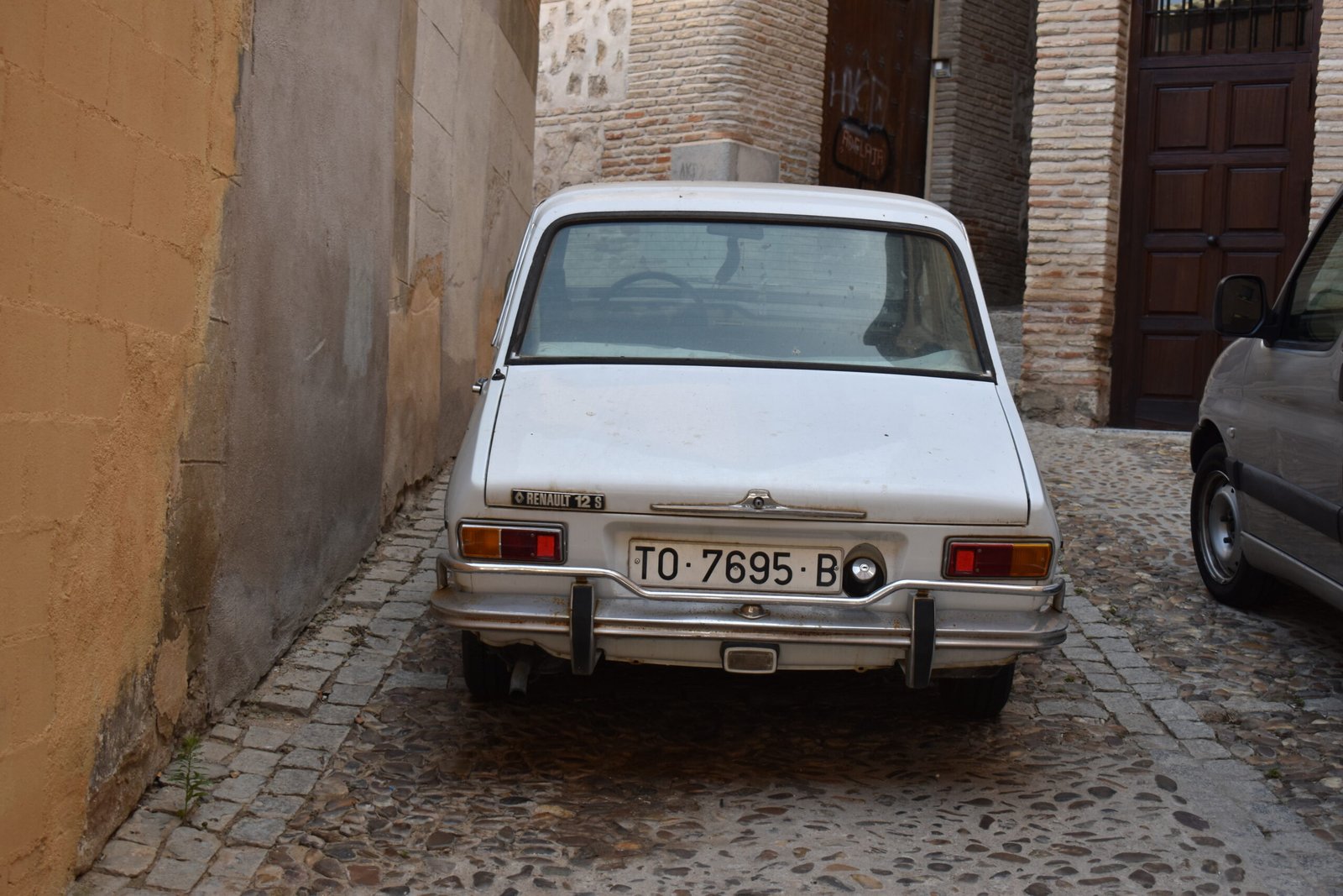 A car parked on a street in Toledo, Spain.